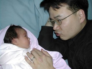 John Kang with his newborn Kristina