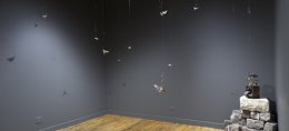 Over 20 bullets are suspended from the ceiling of the Weinberg/ Newton Gallery as part of the exhibit called