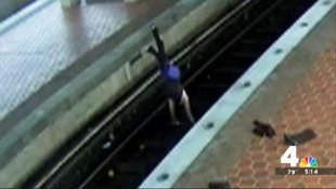 This unidentified woman was filmed doing various yoga moves, including a handstand seen here, after climbing onto subway tracks outside of Washington, D.C.